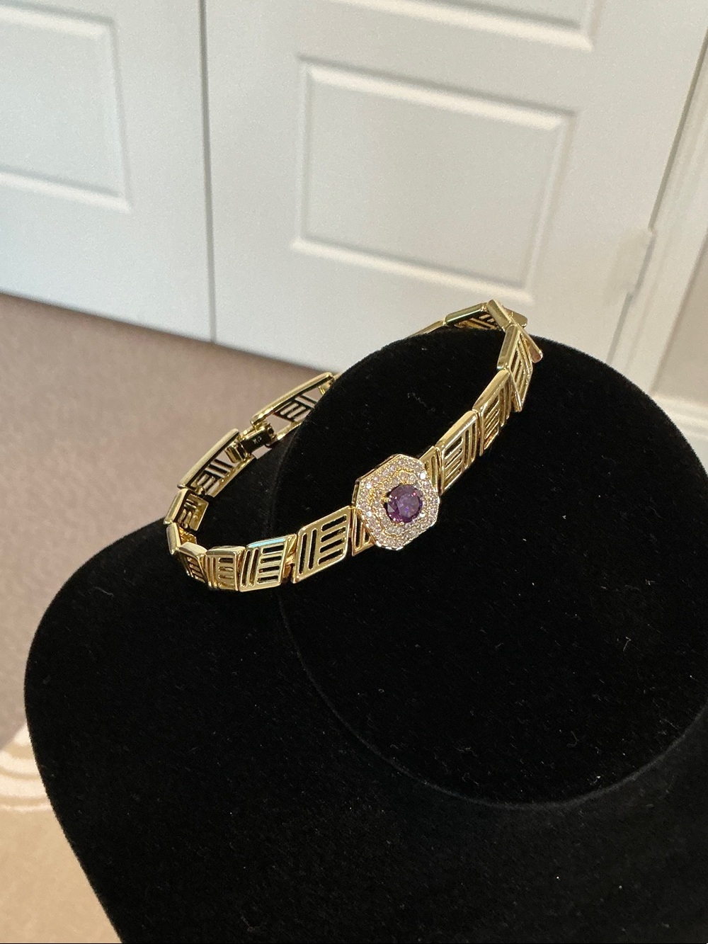 Stunning Gold Tone Bracelet with Pave Stones with Purple Center Stone.
